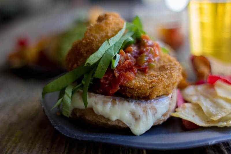 Eggplant lovers this one's for you! Easy Eggplant Parmesan Sandwiches with homemade tomato jam, pesto, lots of melty cheese and fresh ribbons of basil on a toasted sourdough bun! Get the recipe on @beardandbonnet 