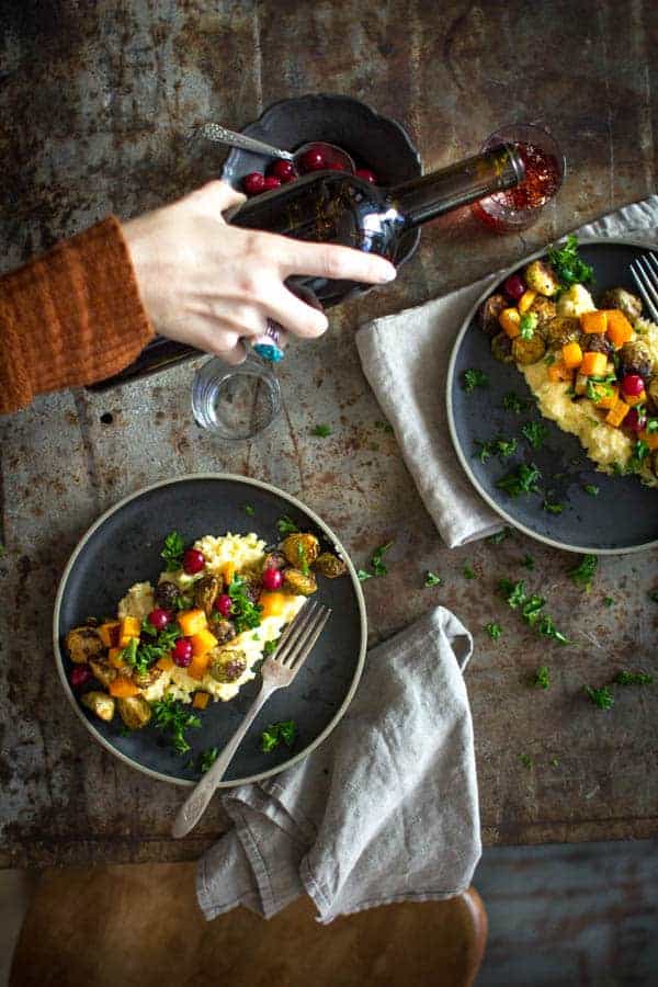 Roasted Brussels and Squash over Creamy Garlic Polenta. The perfect veg friendly main for Thanksgiving! | Vegan & Gluten Free | on @beardandbonnet