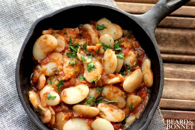 A skillet of Mediterranean-Style Baked Lima Beans