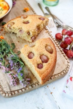 wedges of Olive Oil Cake with Polenta and Roasted Red Grapes
