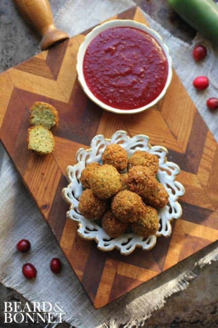 Stuffing Poppers with Cranberry Jalapeno Dipping Sauce on a wooden board