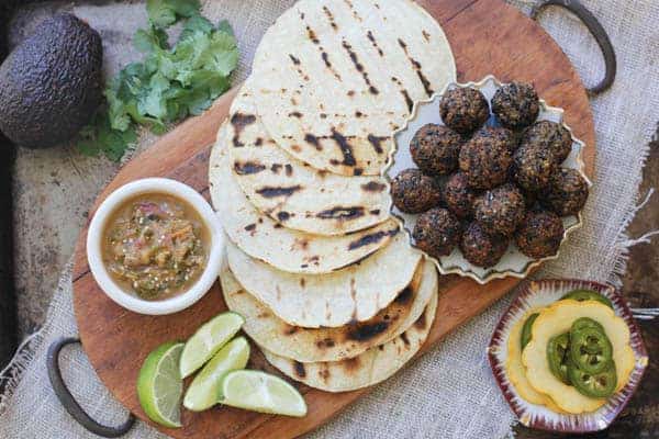 Ingredients for black bean falafel tacos on a table ready to be assembled