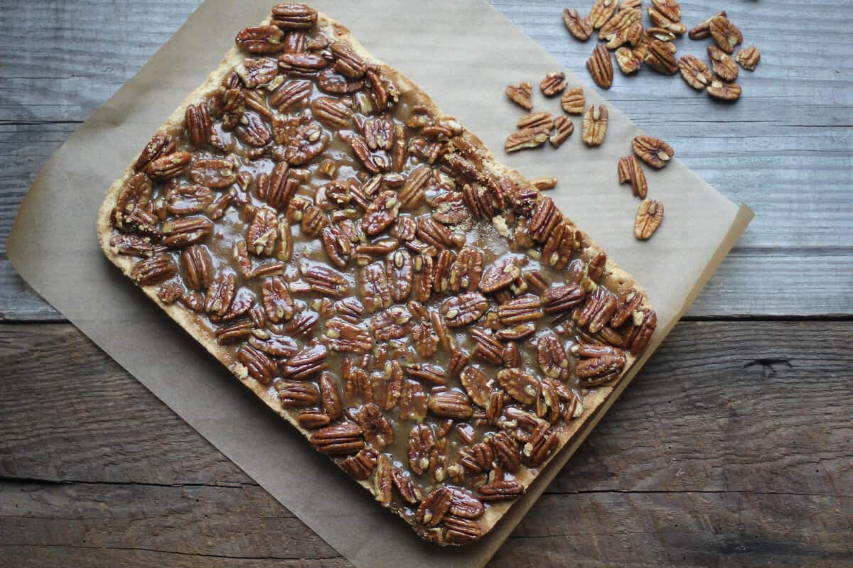 a batch of pecan pie bars on wooden surface