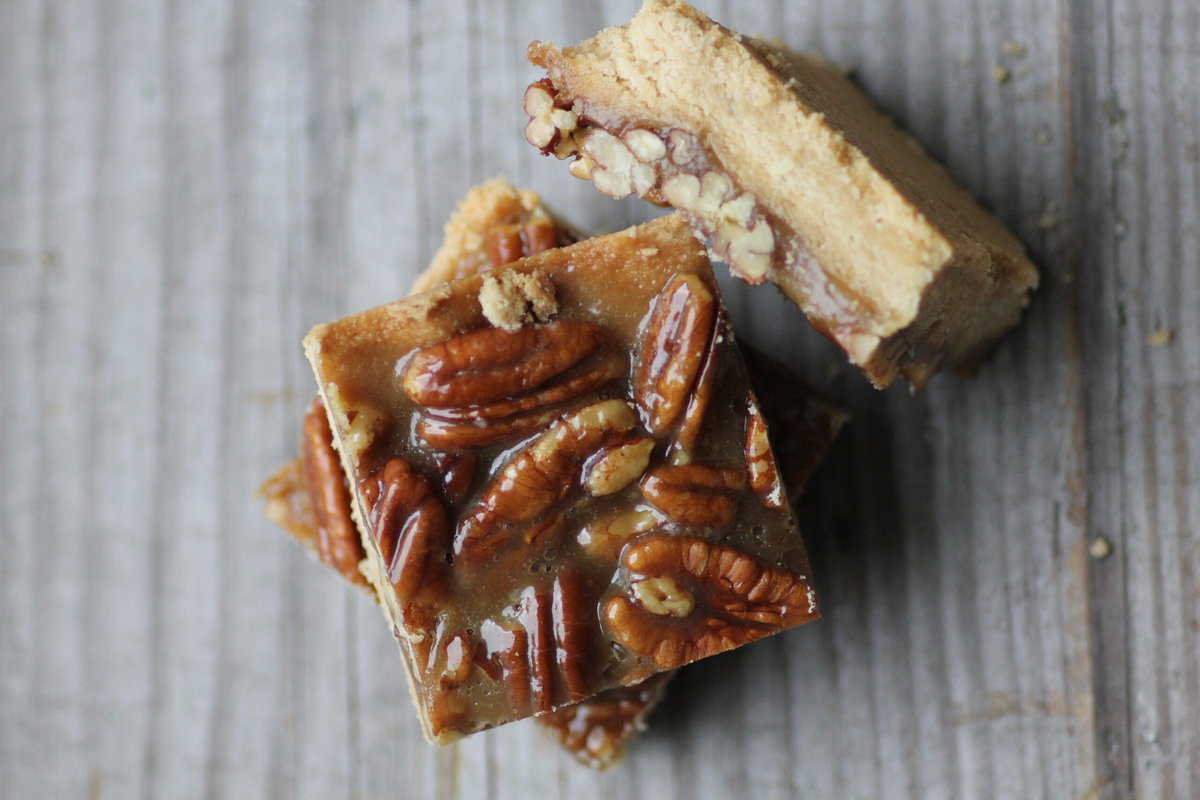 Close up shot of squar pecan pie cars stacked on one another