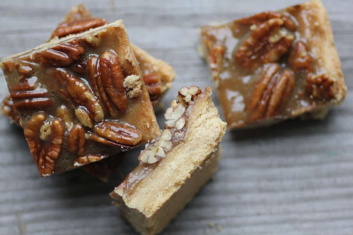 A stack of pecan pie bars  on a wooden board