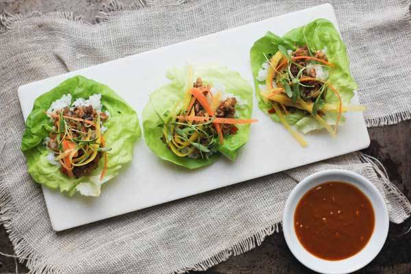 lettuce wraps with sushi rice, vegetarian mushroom, water chestnut, and walnut filling with shredded carrots, micro greens and homemade hoisin sauce
