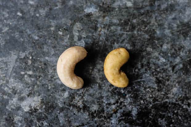 A raw cashew and a raw cashew that has been soaked in filtered water overnight next to each other to show size difference. 