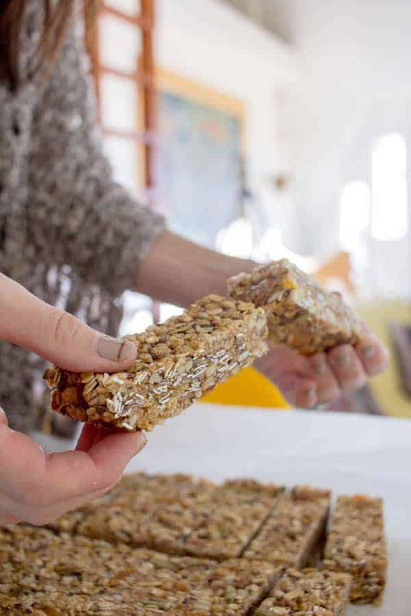 A woman holding a rise and shine energy bar