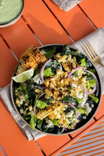 grilled corn salad with red onions, greens, and Cotija cheese