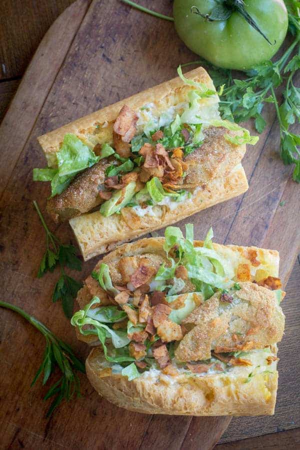 Fried Green Tomato Po'Boys recipe || Whether you are serving this with coconut bacon for a vegetarian sandwich or with real crispy oven baked bacon this sandwich is not to be missed! || @thismessisours
