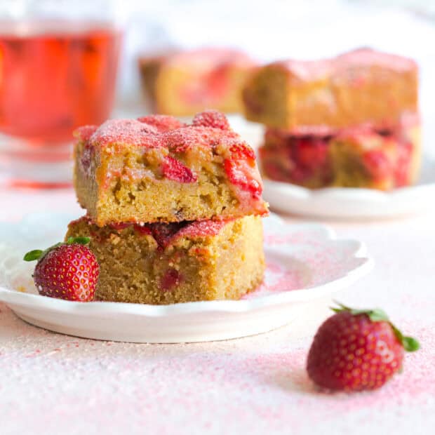 Strawberry Blondies on white plate on pink board