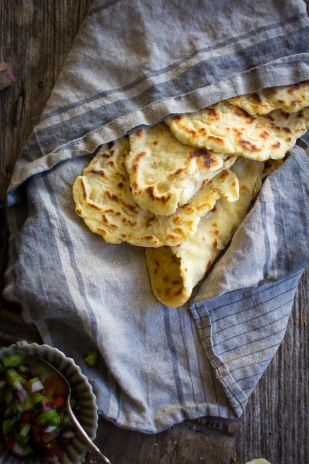 Gluten Free Roasted Garlic Naan in a basket lined with a linen