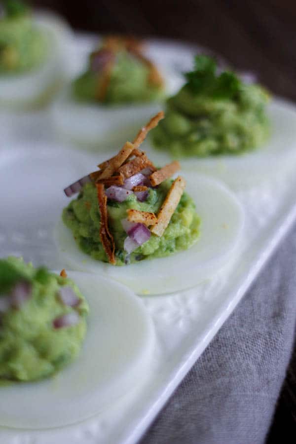 Chips and Guac Deviled Eggs recipe || These deviled eggs are a total game changer! If you love to snack on guacamole and tortilla chips than this update to the classic deviled egg recipe is going to have you swooning! || @thismessisours #glutenfree