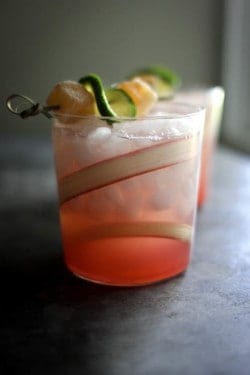 A Rhubarb Ginger Beer Margarita with a fresh rhubarb swirl garnish in the glass