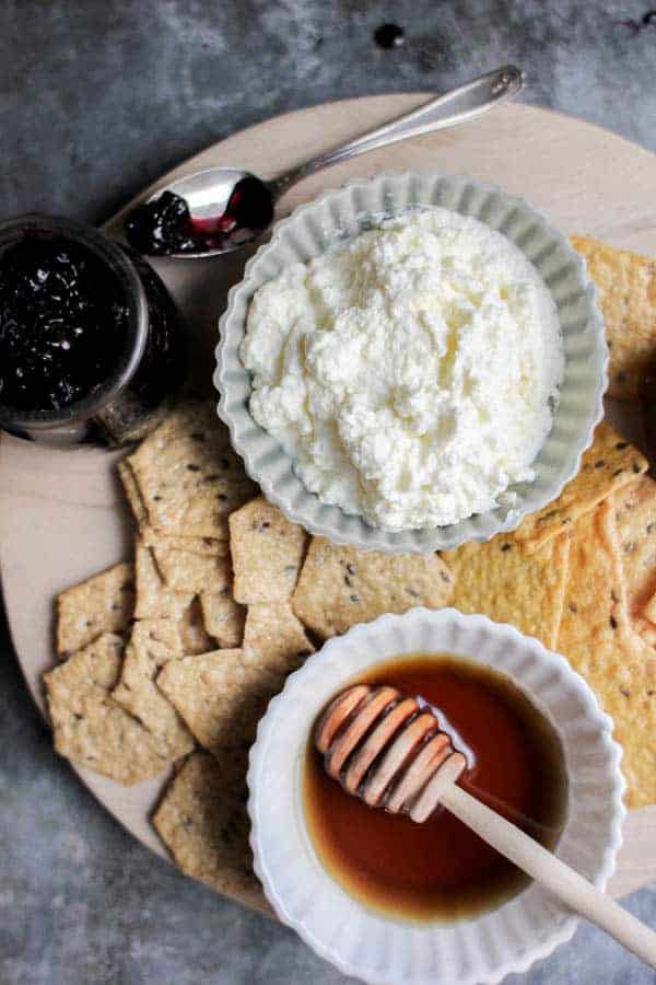 Red, White, and Blue Dunk and Slather Board recipe || Decadent homemade ricotta pairs perfectly with homemade jam flavors like blueberry lavender and strawberry rose. They make for the perfect snack platter when paired with @crunchmaster crackers. || @thismessisours #glutenfree #vegetarian #spon