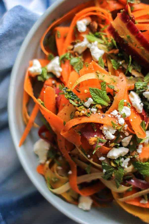 Carrot, Feta, and Pistachio Salad with Orange Blossom Toss recipe from @KaleandCaramel || Beautiful heirloom carrots thinly shaved & tossed with an incredible orange blossom scented dressing, herbs, pistachios, and feta. || @thismessisours #glutenfree #vegetarian