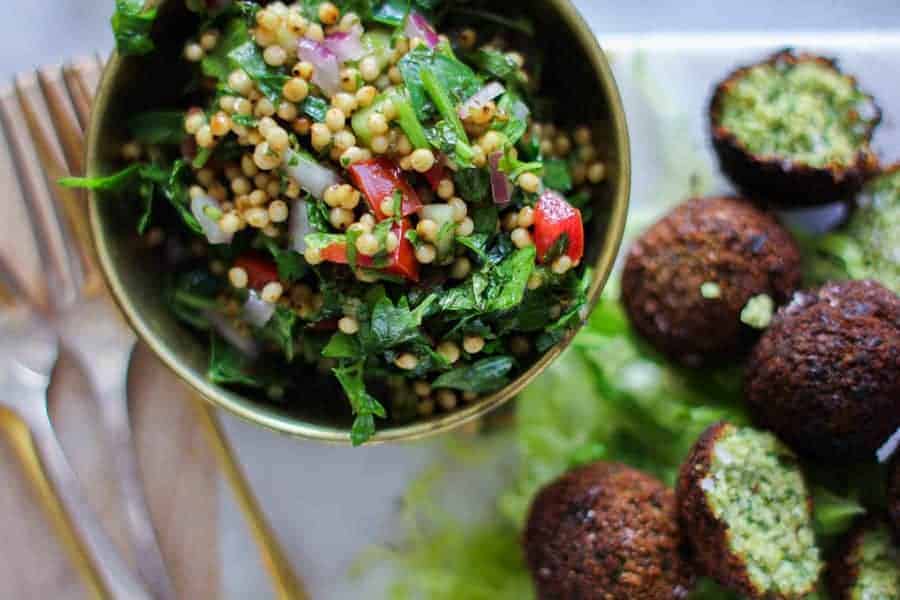 Sorghum Tabbouleh made with sorghum, tomatoes, parsley, and onions served with falafel