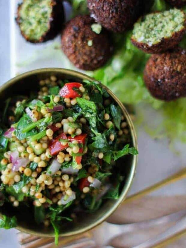 Sorghum Tabboulehin a small bowl next to a platter of falafel