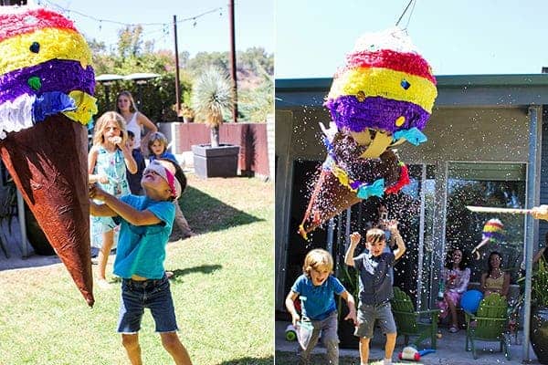 How to Host an Ice Cream Social || The kids had so much fun taking turns trying to burst this ice cream piñata! It was chock full of tasty treats to take home and colorful paper confetti || @thismessisours #FriendsWhoFete