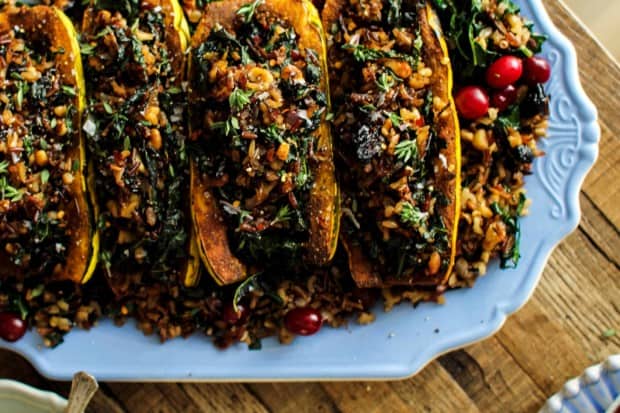 Exotic Rice Stuffed Delicata Squash with Curried Cashew Cream recipe || These curry spiced delicata squash are filled to the brim with an exotic rice blend loaded with onion, garlic, walnuts, kale, and dried bing cherries. This dish is the perfect plant based main dish for your holiday table! || @thismessisours @nutsdotcom