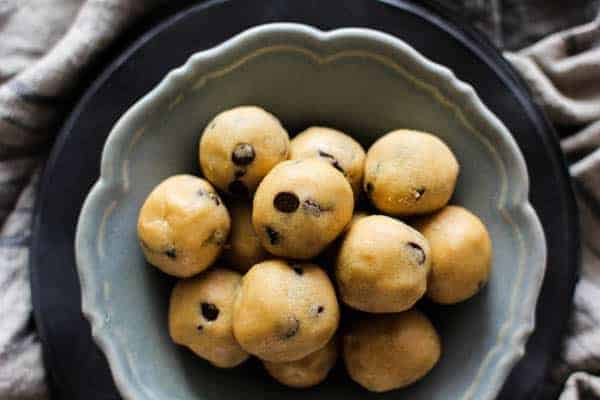 Peanut Butter Chocolate Chip Cookie Dough Bites recipe || Who doesn't love cookie dough?! Honestly, I think we like the dough more than the actual cookies which is why we created this egg free, no bake recipe that makes indulging in the best part of the cookie making process worry free! || @thismessisours #ad @cloversonoma #glutenfree #vegetarian #CheersToTraditions