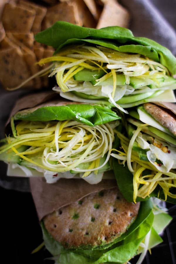 Green Goddess Sandwich recipe || These delicious sandwiches are loaded with all the sandwich essentials; butter lettuce, thinly sliced green tomatoes, cucumber, shredded carrots, a slice of Swiss, and a heaping pile of citrus pickled fennel. Plus, they are built on Ozrey One Buns that are slathered in a decadent Green Goddess sandwich spread! || @thismessisours @pitabreak #OzeryBakery #Ozery #OBCreation