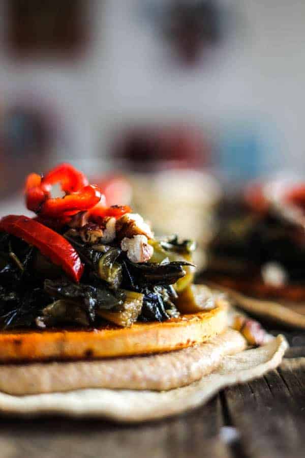 baked tostada with black-eyed pea hummus, roasted sweet potato, and jammy collard greens