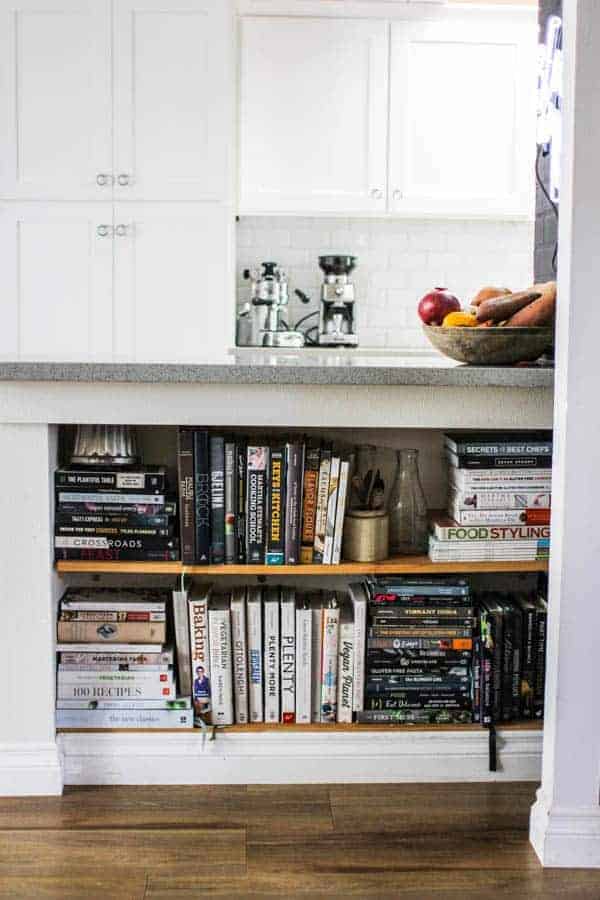 cookbook collection on shelves in kitchen