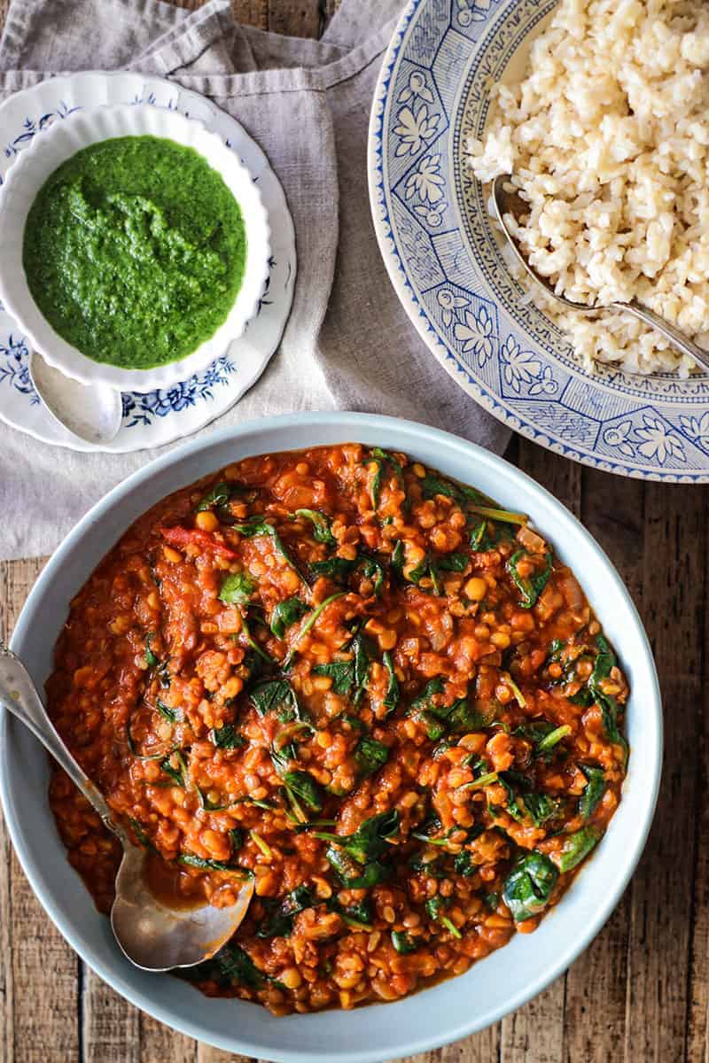 Bowls of curry, brown rice, and cilantro chutney