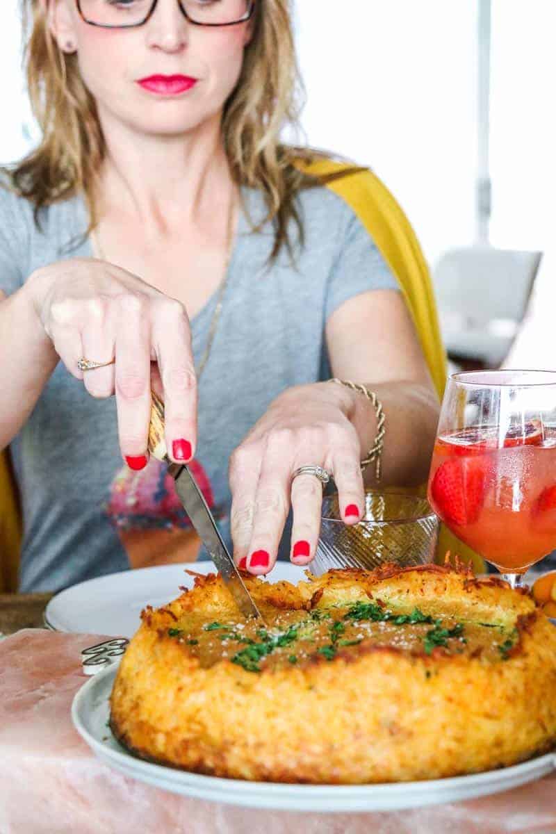 Spinach and Onion Quiche with Hash Brown Crust being sliced