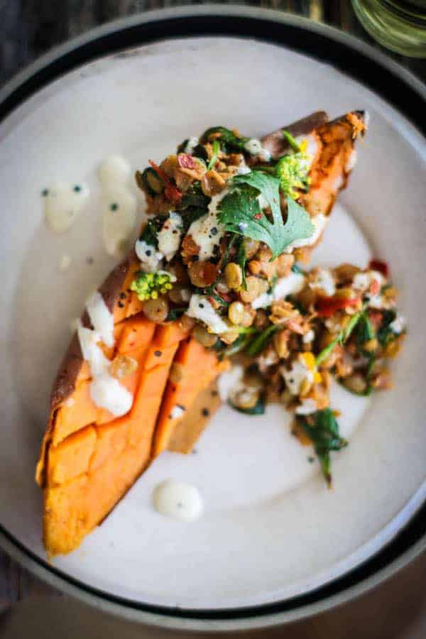 Roasted sweet potato smothered in Moroccan spiced lentils then drizzled with tahini dressing