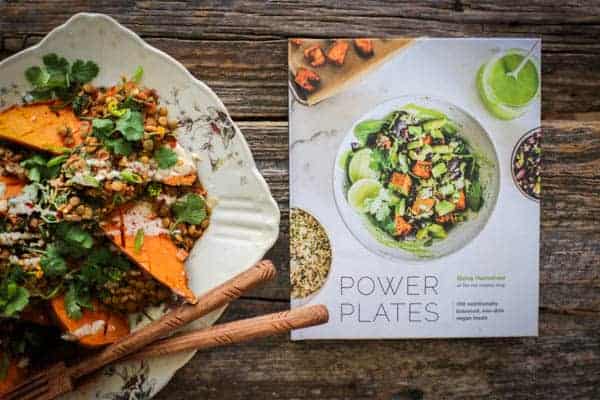 Roasted sweet potato smothered in Moroccan spiced lentils then drizzled with tahini dressing and a copy of the cookbook Power Plates