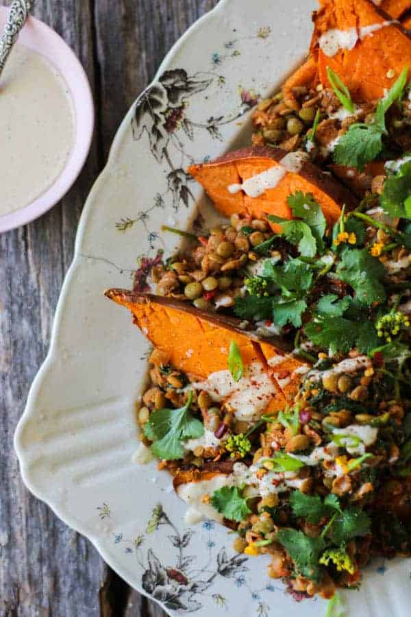 Roasted sweet potatoes smothered in Moroccan spiced lentils then drizzled with tahini dressing