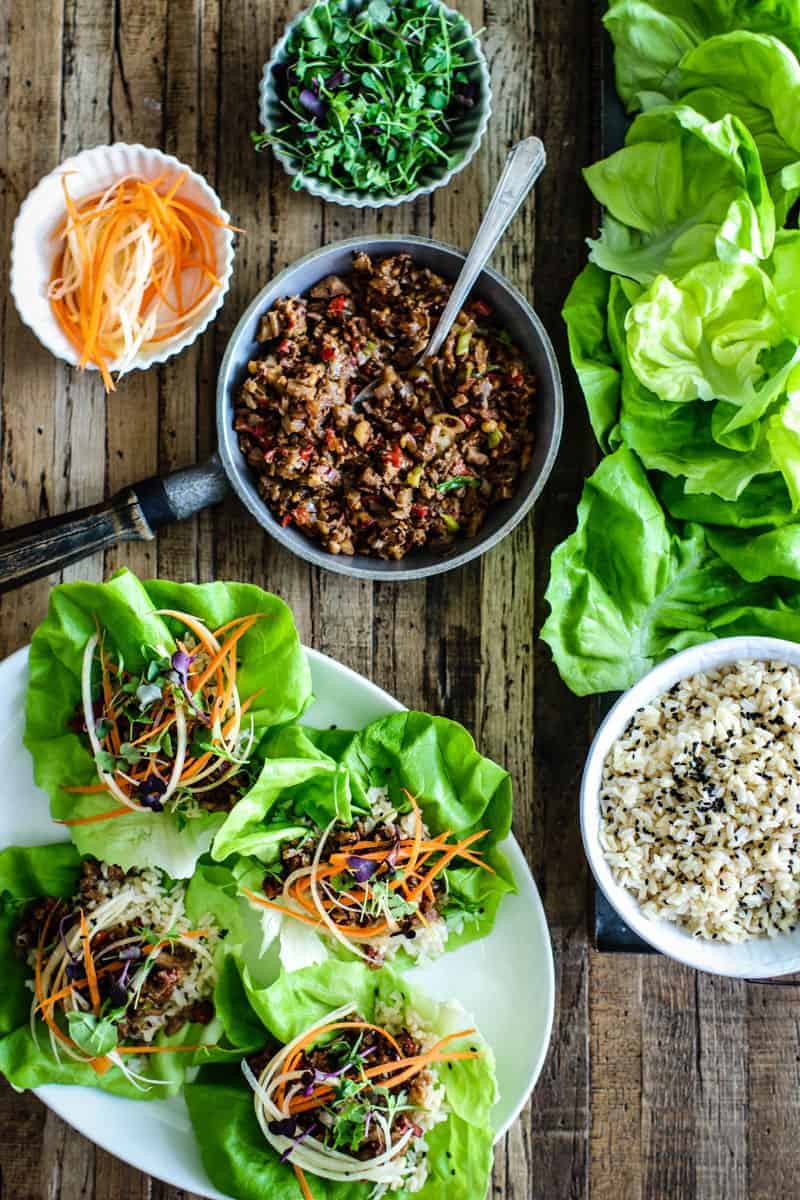 lettuce cups with brown rice, hoisin mushroom filling, shredded carrots, micro greens, and sesame seeds.