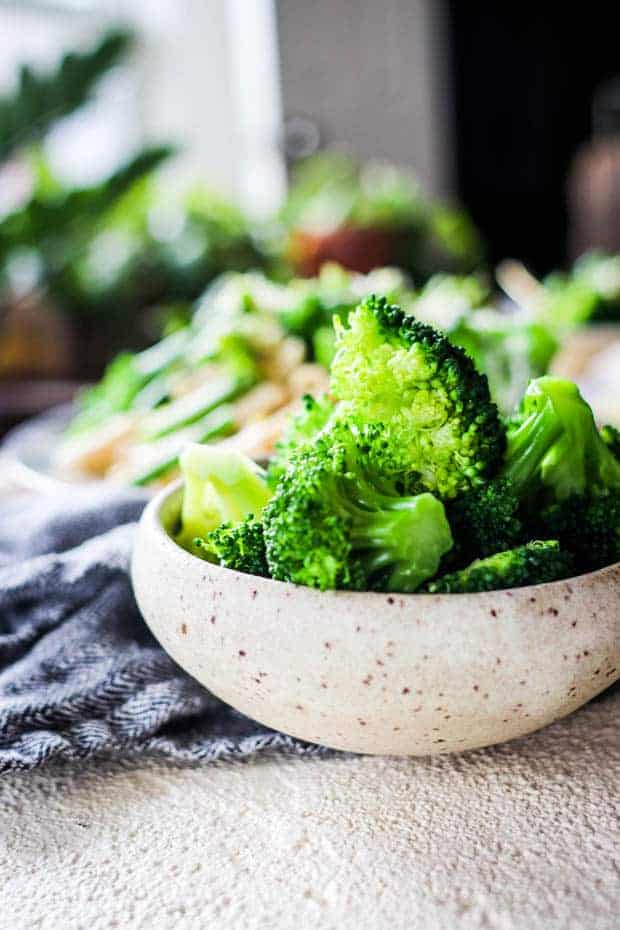 A bowl of vibrant green blanched broccoli