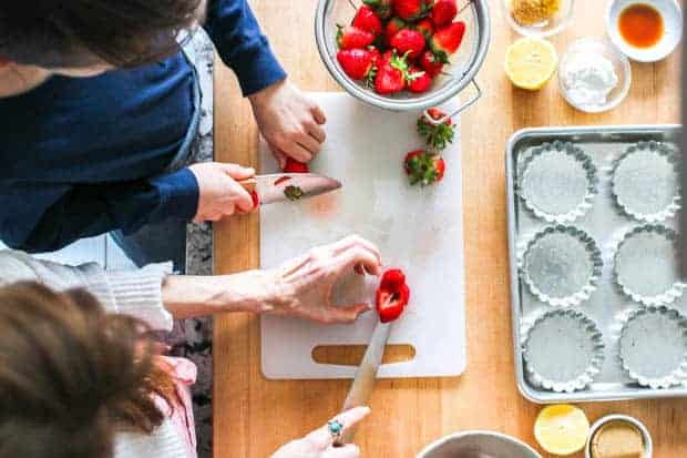 A boy and his mom making Individual Strawberry Crisps 