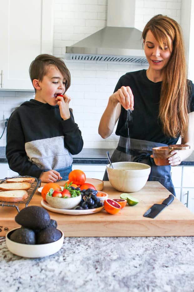 A woman and a young boy making Fruity Avocado Toast together