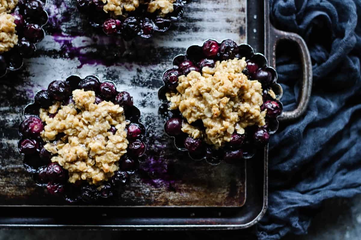 4 small individual pans of blueberry crisps.