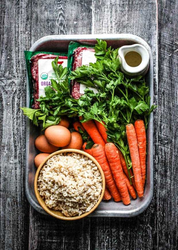 Ingredients needed to make homemade dog food in a big baking dish