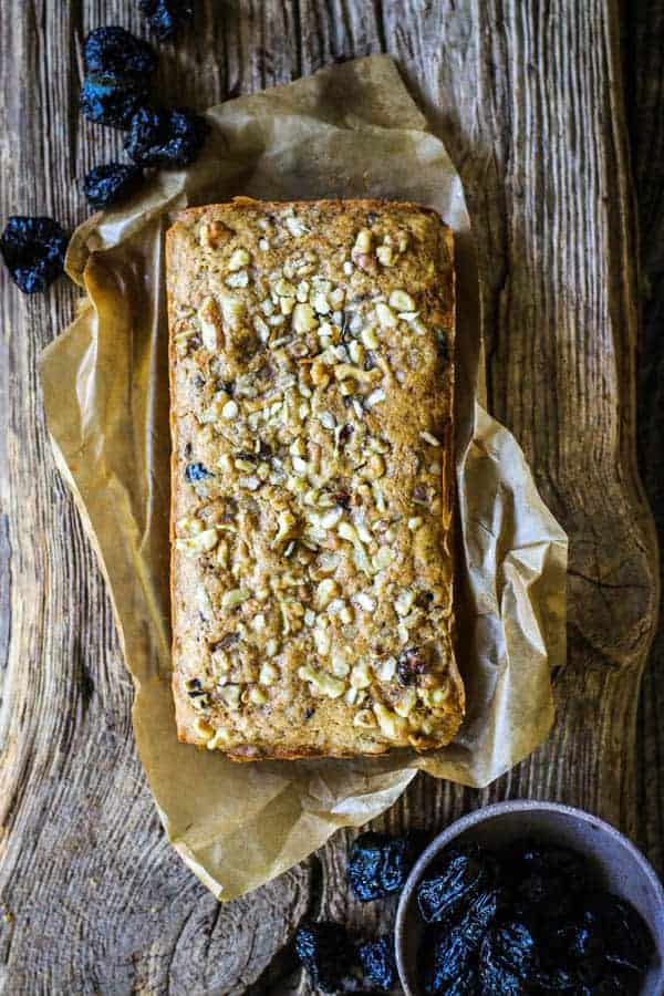 Coffee cake recipe before being sliced on a brown piece of parchment. 