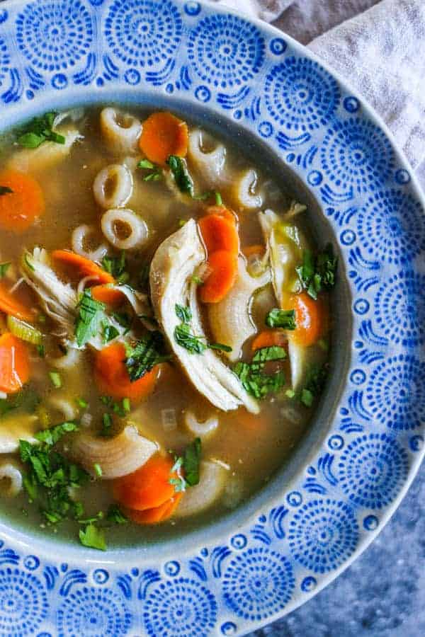 A bowl of homemade chicken stock made using The Easiest DIY Rotisserie Chicken Broth 