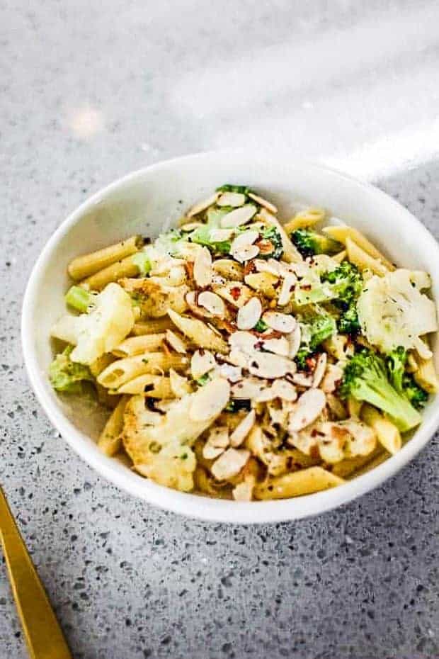 Bowl of lemon pasta with broccoli and cauliflower