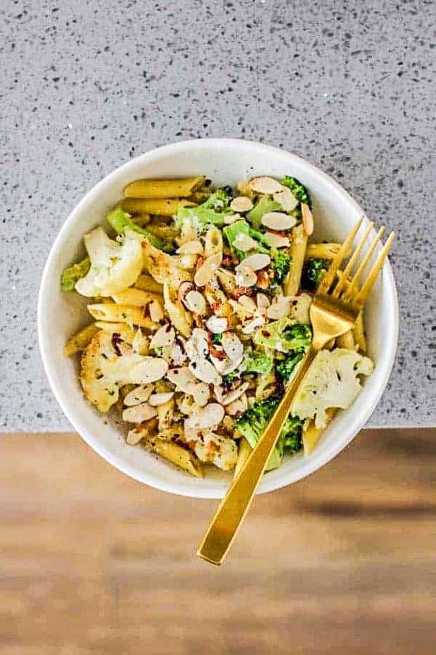 Overhead view of bowl of lemon pasta with broccoli and cauliflower