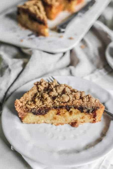 A slice of Weekend Coffee Cake Crumble on a white dessert plate