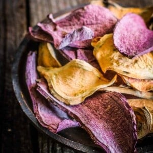 A bowl of red and purple sweet potato dog treats