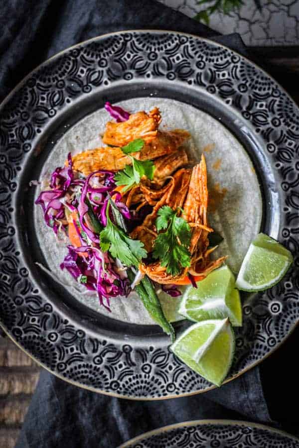 Two shredded chicken tacos on a plate