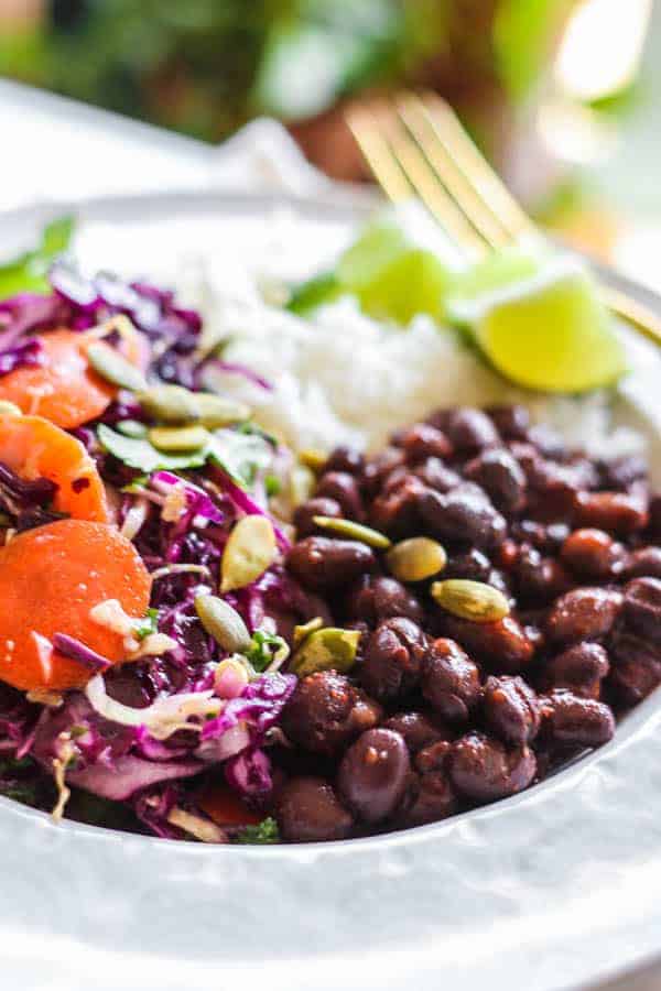 A close up of black beans in a burrito bowl