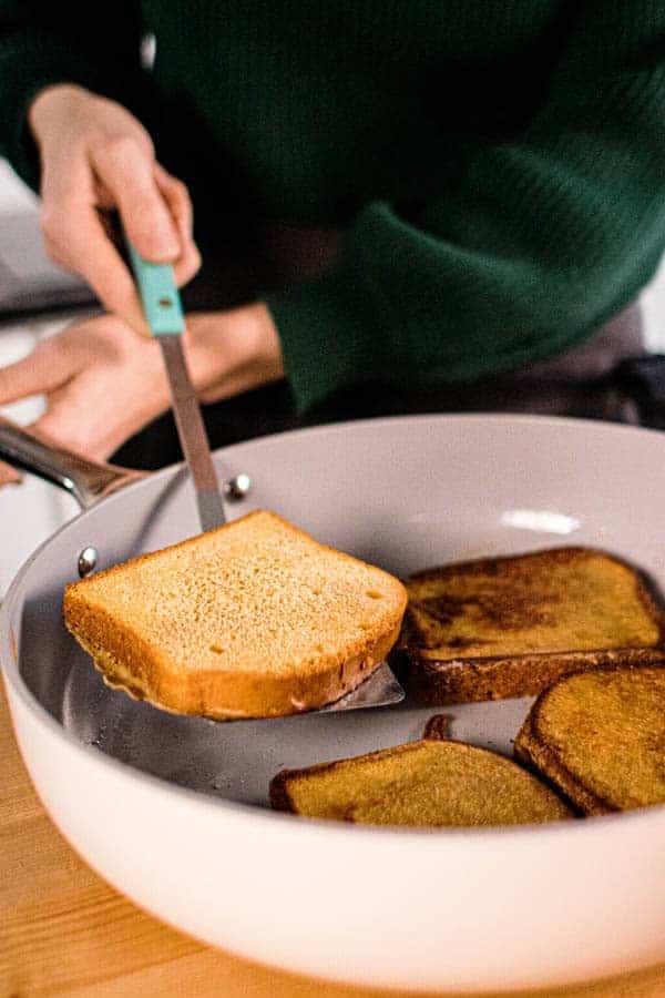 French toast in a skillet being flipped