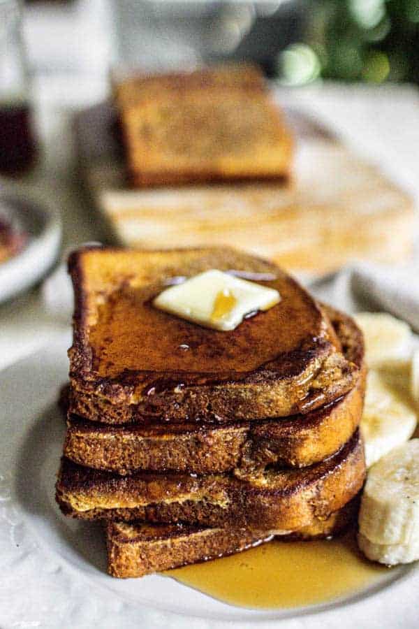 A stack of French toast with butter and maple syrup