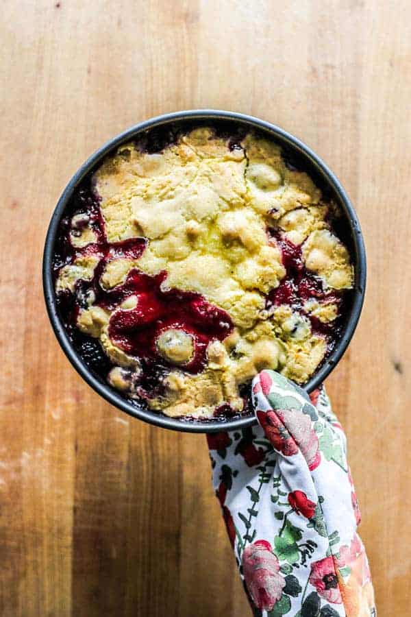 A baked black and blueberry cobbler fresh from the oven.